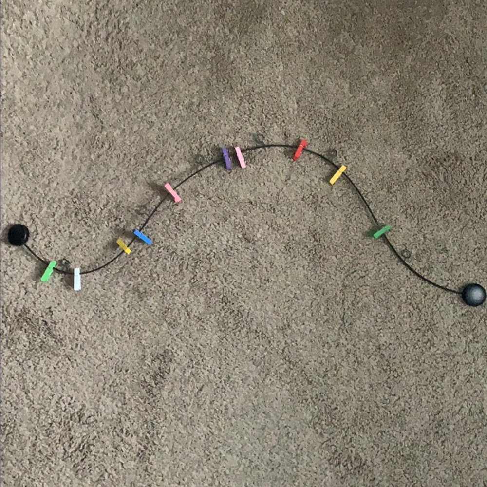 Wall string with colorful clothespins to hang pics